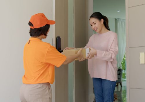 Asia people female girl success pickup free fast express good postal post mail support from e-shopping retail order online e-commerce store postmate worker carry container at door home city life.